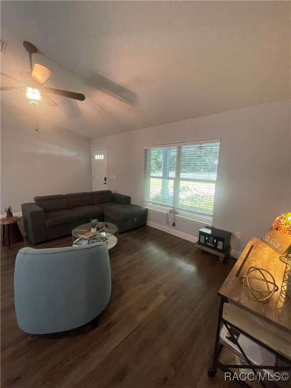 living room featuring lofted ceiling, ceiling fan, and dark hardwood / wood-style floors