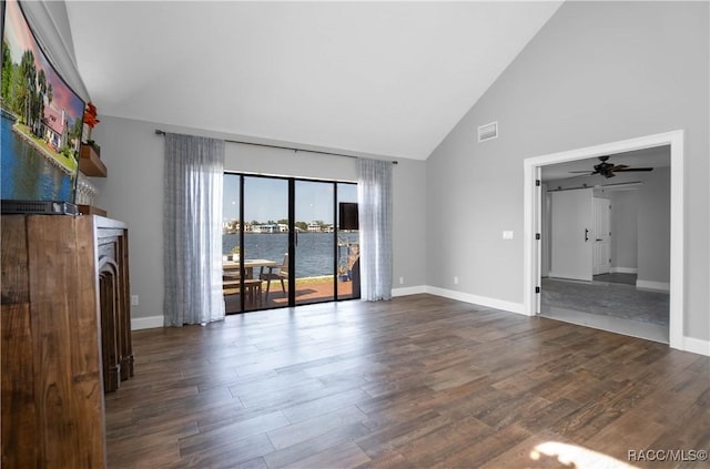 unfurnished living room featuring baseboards, high vaulted ceiling, visible vents, and wood finished floors