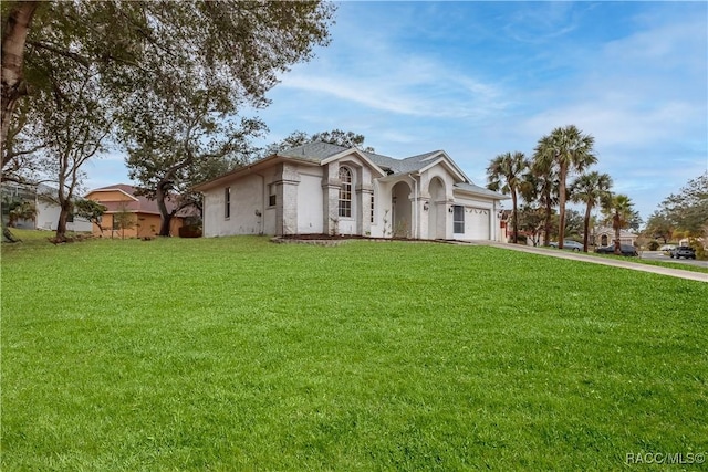 view of front of home featuring a garage and a front lawn