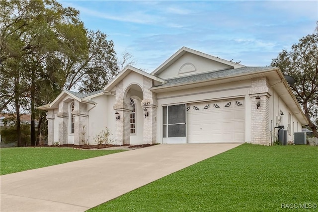 view of front facade with central AC unit, a garage, and a front yard