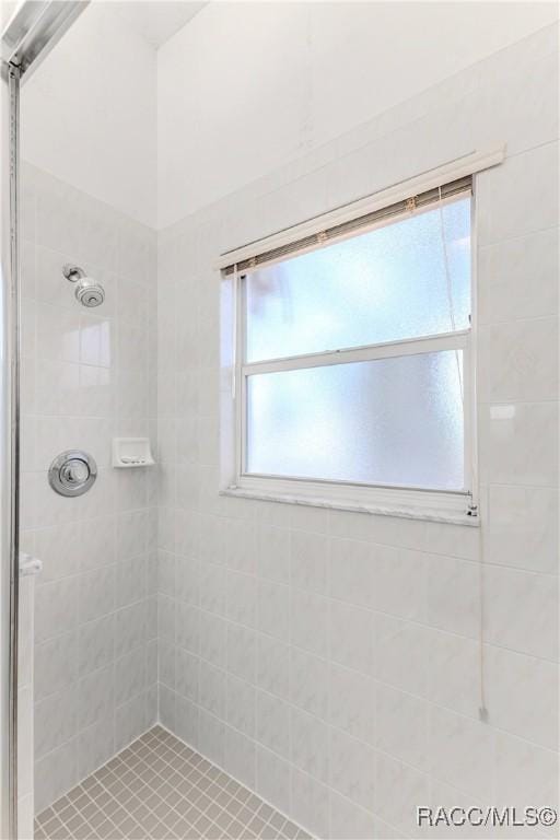 bathroom with tiled shower