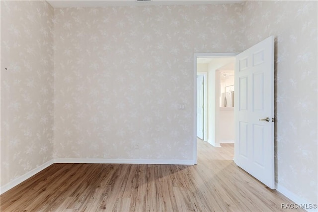 empty room with light hardwood / wood-style flooring