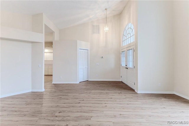 interior space with high vaulted ceiling and light wood-type flooring