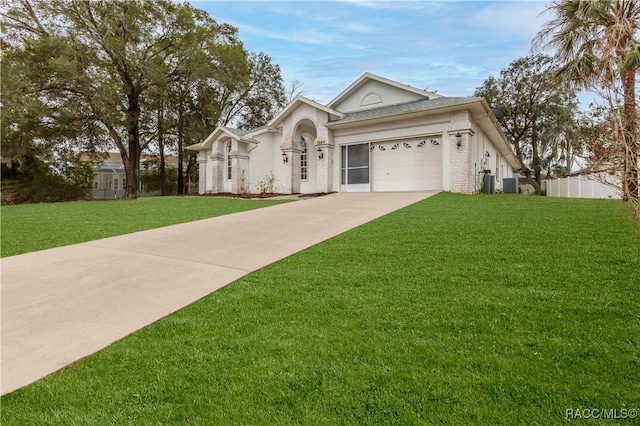 view of front facade featuring cooling unit, a garage, and a front yard