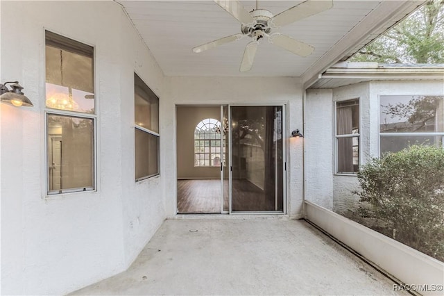 doorway to property featuring ceiling fan and a patio area