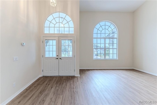 entryway featuring french doors and light wood-type flooring