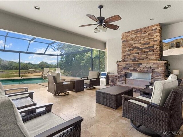 2622 N Carnoustie Loop, Lecanto, FL 34461 - view of patio / terrace with an outdoor living space with a fireplace, an outdoor pool, a ceiling fan, and a lanai