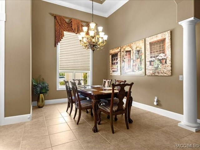 2622 N Carnoustie Loop, Lecanto, FL 34461 - tiled dining area featuring decorative columns, baseboards, a chandelier, crown molding, and a high ceiling