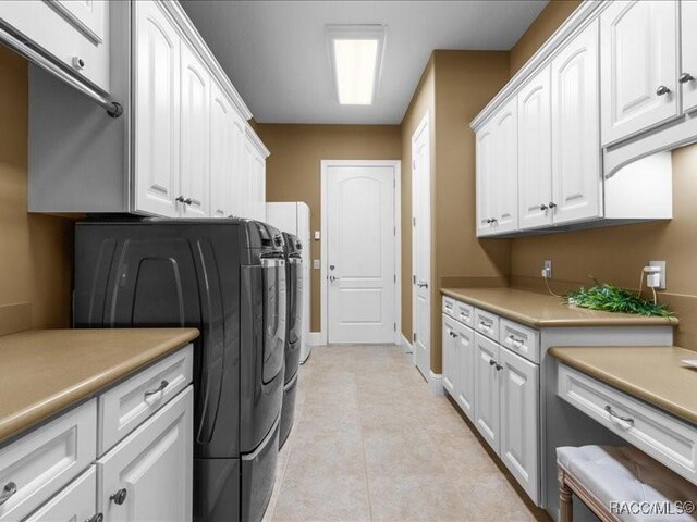 2622 N Carnoustie Loop, Lecanto, FL 34461 - laundry room with cabinet space, washer and dryer, baseboards, and light tile patterned floors