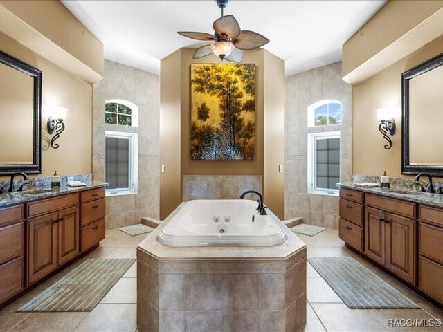 2622 N Carnoustie Loop, Lecanto, FL 34461 - full bath with tile walls, tile patterned flooring, two vanities, and a tub with jets