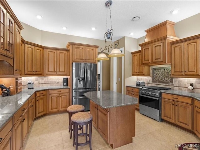 2622 N Carnoustie Loop, Lecanto, FL 34461 - kitchen featuring stainless steel appliances, a kitchen island, decorative backsplash, brown cabinetry, and recessed lighting