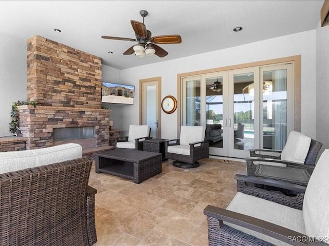 2622 N Carnoustie Loop, Lecanto, FL 34461 - living room with a ceiling fan, french doors, and a stone fireplace