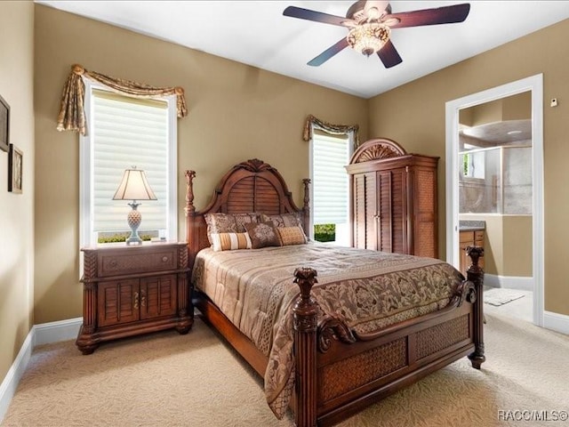 2622 N Carnoustie Loop, Lecanto, FL 34461 - carpeted bedroom featuring baseboards, ensuite bath, and a ceiling fan