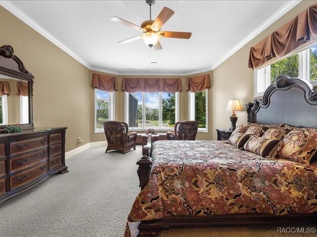 2622 N Carnoustie Loop, Lecanto, FL 34461 - bedroom featuring carpet flooring, crown molding, baseboards, and ceiling fan