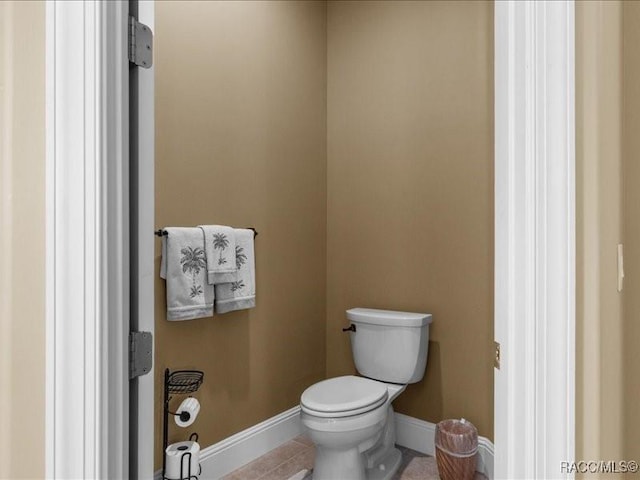 2622 N Carnoustie Loop, Lecanto, FL 34461 - bathroom featuring toilet, baseboards, and tile patterned flooring