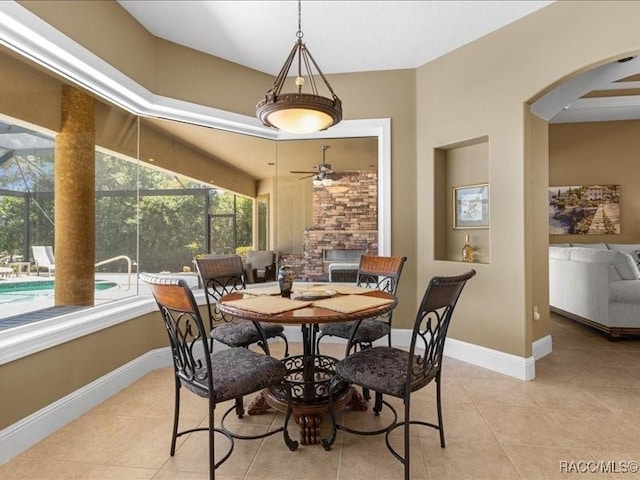 2622 N Carnoustie Loop, Lecanto, FL 34461 - dining area featuring arched walkways, a ceiling fan, light tile patterned flooring, and baseboards