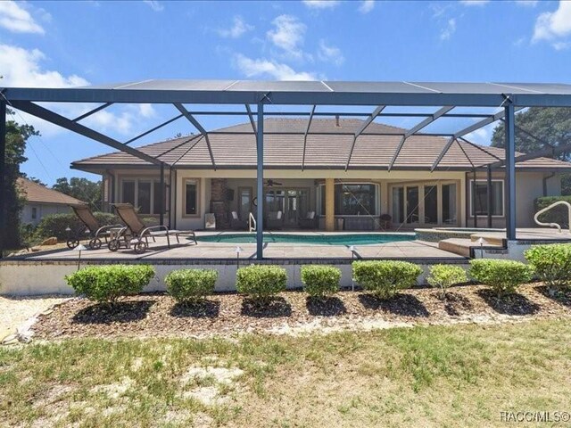 2622 N Carnoustie Loop, Lecanto, FL 34461 - back of property featuring ceiling fan, a patio, an outdoor pool, and a lanai