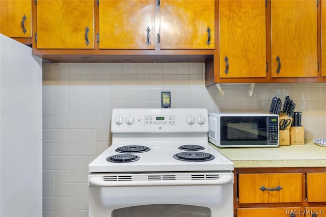 kitchen featuring tasteful backsplash and electric stove