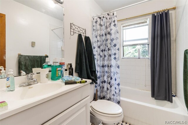 full bathroom featuring shower / bath combo, toilet, and vanity