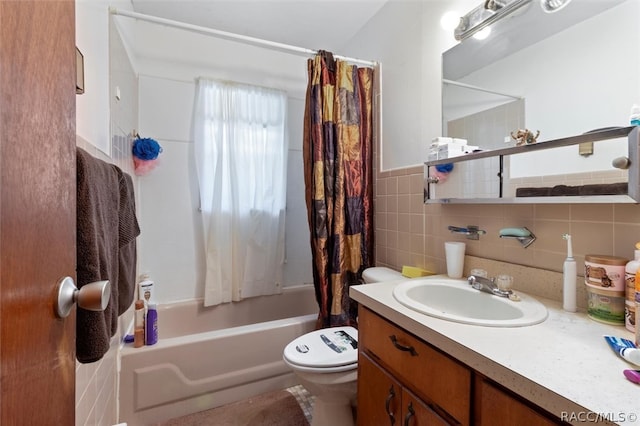 full bathroom featuring vanity, shower / bath combination with curtain, tile walls, and toilet