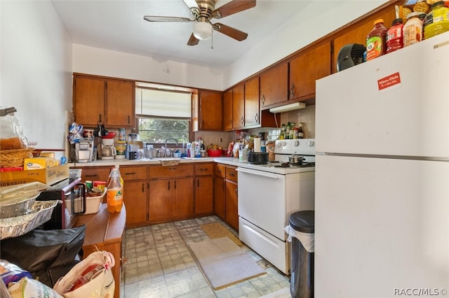 kitchen with white appliances, ceiling fan, and sink