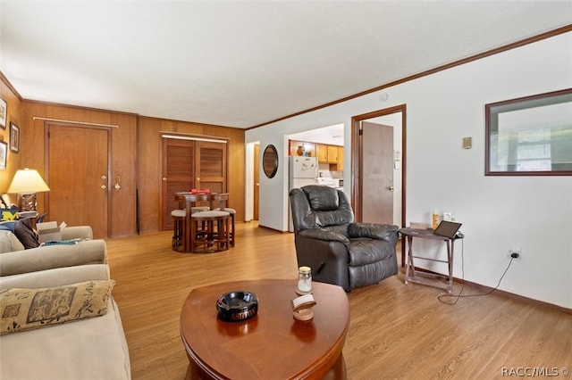 living room with light hardwood / wood-style floors and ornamental molding