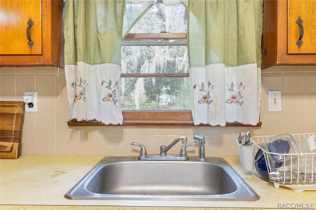 kitchen featuring sink and tasteful backsplash