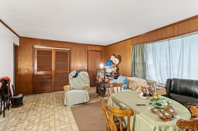 living room featuring ornamental molding and wood walls