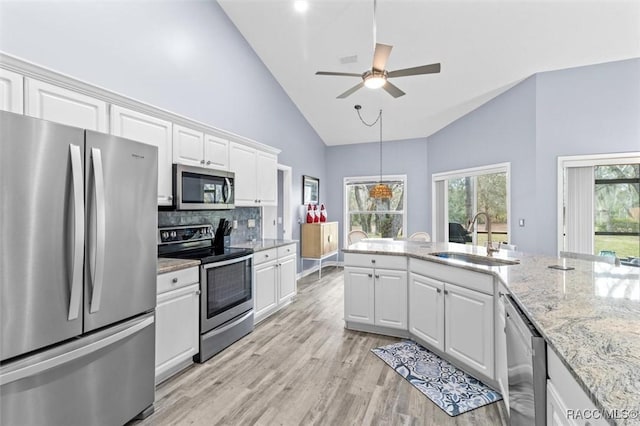 kitchen with decorative backsplash, white cabinetry, sink, and appliances with stainless steel finishes