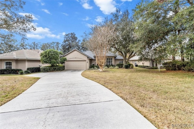 ranch-style home with a garage and a front lawn