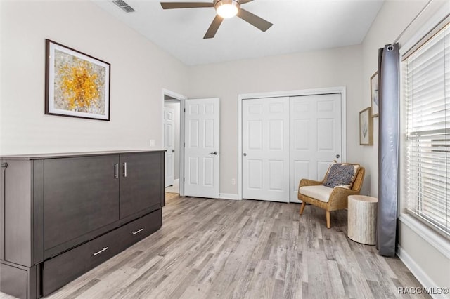 sitting room with ceiling fan and light hardwood / wood-style flooring