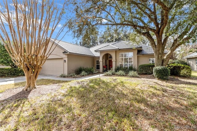 view of front facade with a front yard and a garage