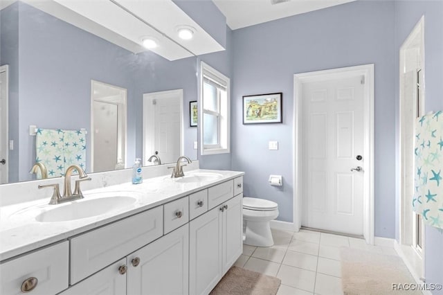 bathroom featuring tile patterned flooring, vanity, toilet, and a shower with door