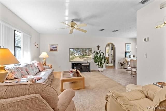 living room featuring ceiling fan and light colored carpet