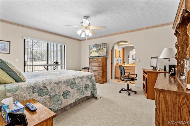 carpeted bedroom featuring ceiling fan, a textured ceiling, and ornamental molding