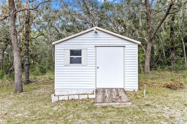 view of outbuilding featuring a lawn