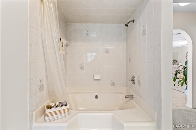 bathroom with tile patterned floors and shower / tub combo with curtain