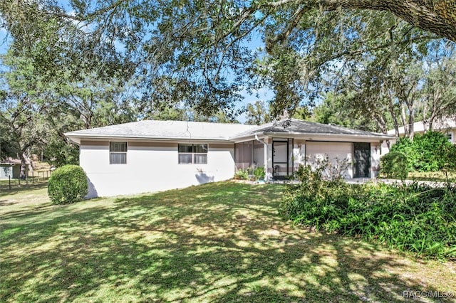 single story home with a garage and a front lawn