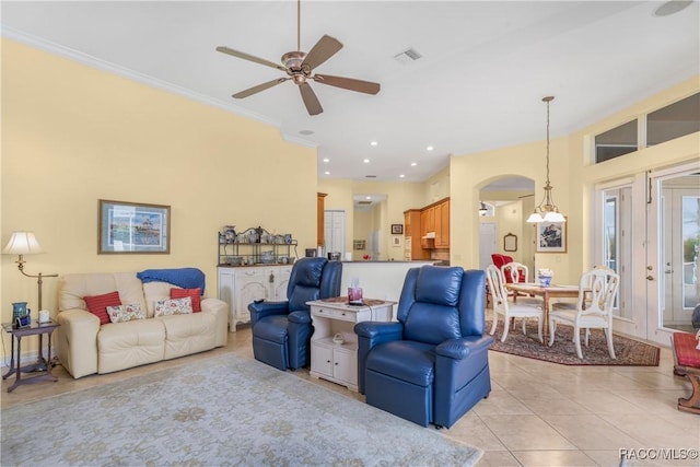 tiled living room with ceiling fan and ornamental molding