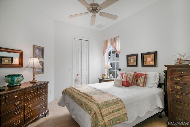 bedroom featuring ceiling fan, a closet, and light tile patterned floors