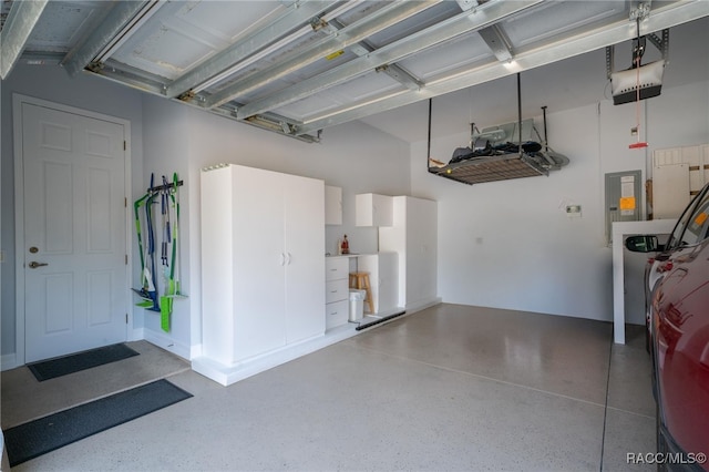 garage with a garage door opener and electric panel