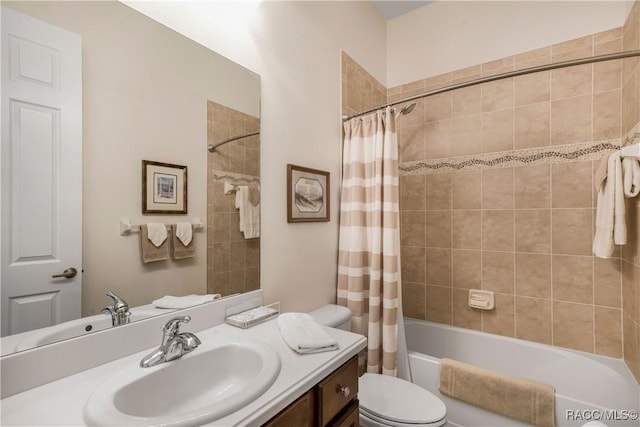 full bathroom featuring shower / tub combo with curtain, vanity, and toilet