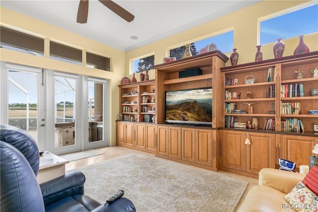 living room with crown molding, light tile patterned floors, ceiling fan, and french doors