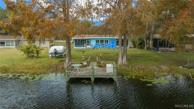 view of dock featuring a yard and a water view