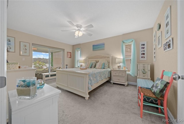 bedroom with ceiling fan and light carpet