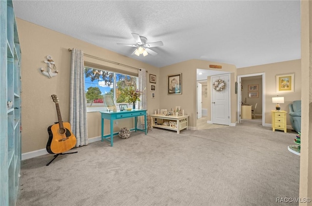 miscellaneous room with ceiling fan, carpet, and a textured ceiling