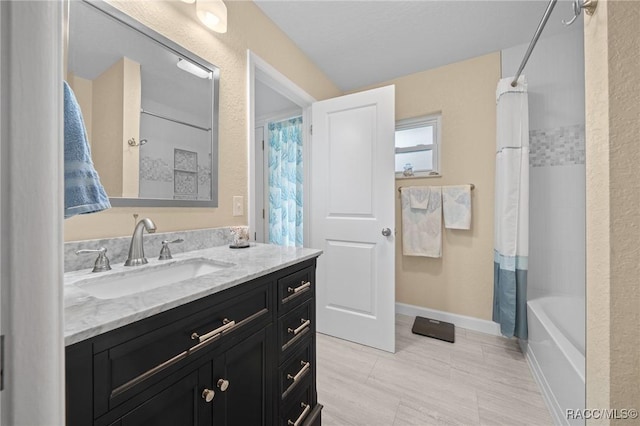 bathroom featuring vanity and shower / bath combination with curtain