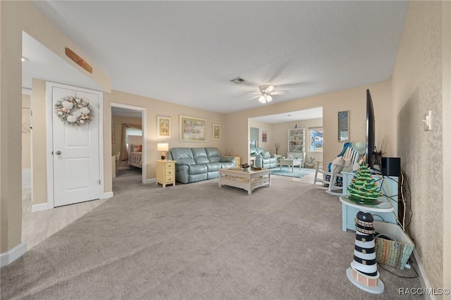 living room featuring ceiling fan and light colored carpet