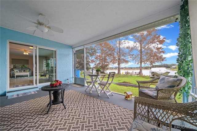 sunroom featuring a wealth of natural light and ceiling fan