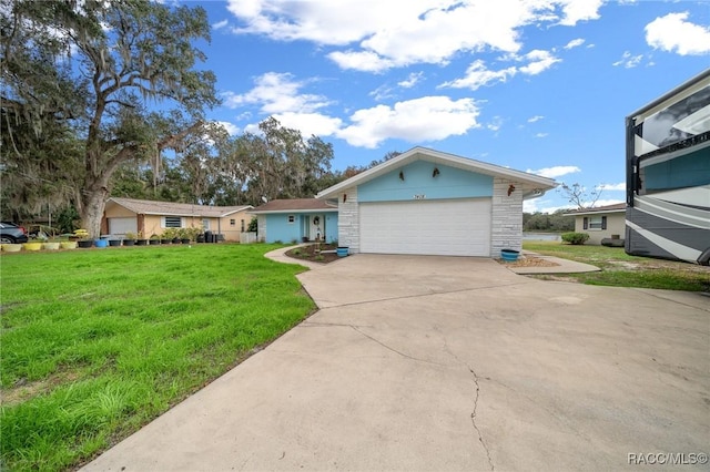 view of front of home with a garage and a front lawn